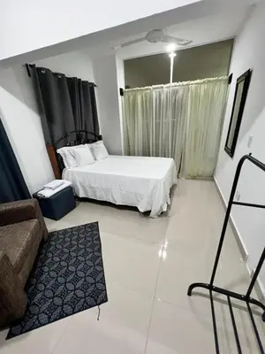 a bedroom with a bed and a couch in it at The Omelís House in Santa Bárbara de Samaná