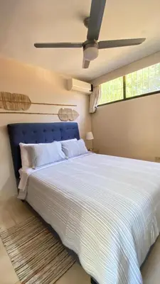 a bedroom with a large bed with a blue headboard at Apartamento en Proyecto Frente al Mar en Sosua in Los Altos de Jalisco