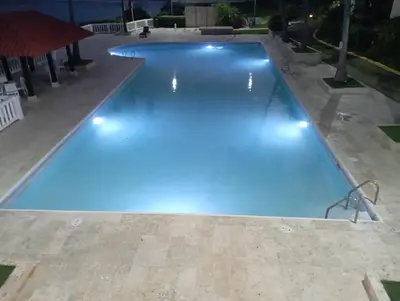 a swimming pool with blue lights on it at Apartamento en Proyecto Frente al Mar en Sosua in Los Altos de Jalisco