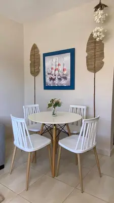 a dining room with a table and four chairs at Apartamento en Proyecto Frente al Mar en Sosua in Los Altos de Jalisco