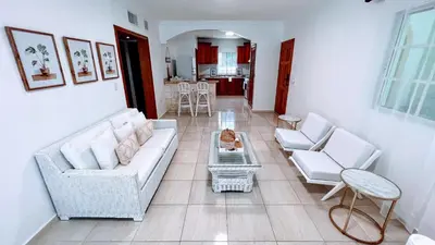 a living room with a couch and chairs and a table at Pool View, Walk to Beach, Shops, Dining, Fast Wifi in Punta Cana