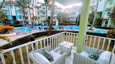 a view of the pool from the balcony of a resort at Pool View, Walk to Beach, Shops, Dining, Fast Wifi in Punta Cana