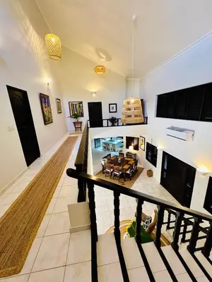 a living room with a table and a swimming pool at Villa Marina in Sosúa
