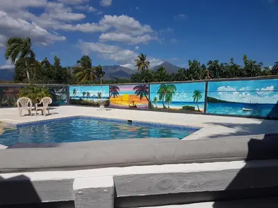 a swimming pool with a mural of the ocean at Finca im Grünen, sehr ruhige Lage, Terrasse mit Pool in Baní