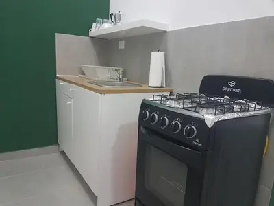 a kitchen with a black stove and a counter at Finca im Grünen, sehr ruhige Lage, Terrasse mit Pool in Baní