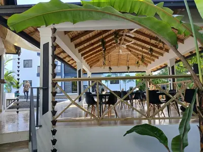 a wooden pergola with a table and chairs under it at aparthotel las taranas in Villa Riva