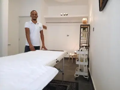 a man standing in a room with two beds at aparthotel las taranas in Villa Riva
