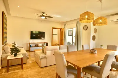 a dining room and living room with a table and chairs at JardinesDelMontSerrat-LasTerrenas-NearBeach Cozy 2BR-3BDS-6PAX-WiFi in Las Terrenas