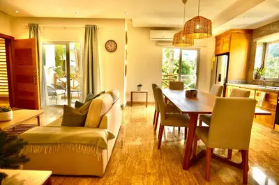 a living room with a table and a couch at JardinesDelMontSerrat-LasTerrenas-NearBeach Cozy 2BR-3BDS-6PAX-WiFi in Las Terrenas