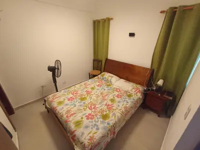 a bedroom with a bed with a flowered bedspread at Casa Maritza in Las Galeras
