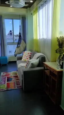 a living room with a couch and a hammock at My Deligth in San Felipe de Puerto Plata