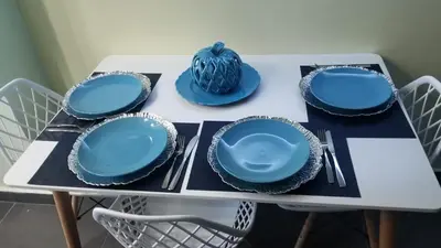 a table with blue plates and napkins on it at My Deligth in San Felipe de Puerto Plata