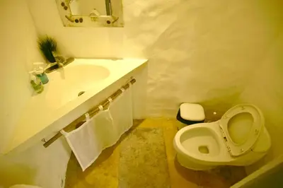 a white bathroom with a sink and a toilet at Villa Valentine LomaBonitaLasTerrenas in Las Terrenas
