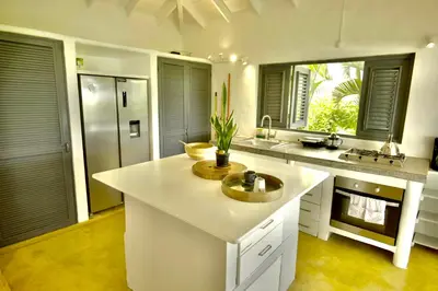 a kitchen with a large white island in a kitchen at Villa Valentine LomaBonitaLasTerrenas in Las Terrenas