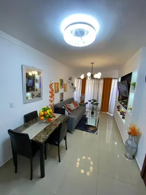 a living room with a table and a couch at 13 de las Americas in La Alianza