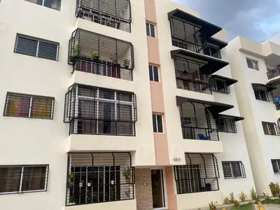 an apartment building with black windows and balconies at 13 de las Americas in La Alianza