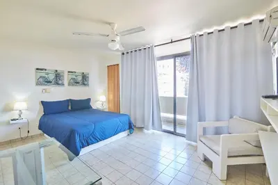 a bedroom with a blue bed and a window at Modern Santo Domingo Condo in Heart of Gazcue in Santo Domingo