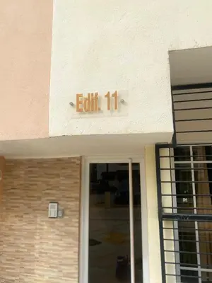 a sign on a building that reads exit at 13 de las Américas in La Alianza