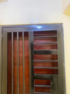 a metal door with the number on it at 13 de las Américas in La Alianza