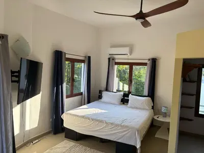 a bedroom with a bed and a ceiling fan at Okaina 7 Penthouse in Cabarete