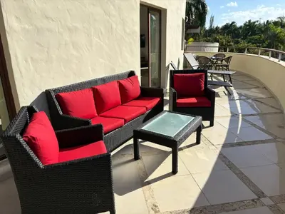 two chairs and a table on a patio at Okaina 7 Penthouse in Cabarete