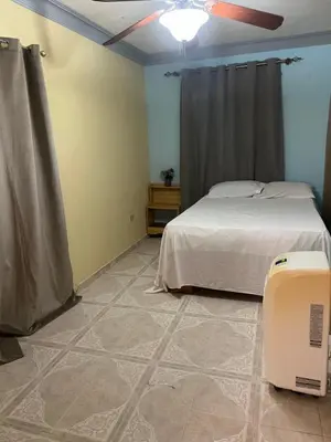a bedroom with a bed and a tiled floor at Hostal Bless house in San Pedro de Macorís