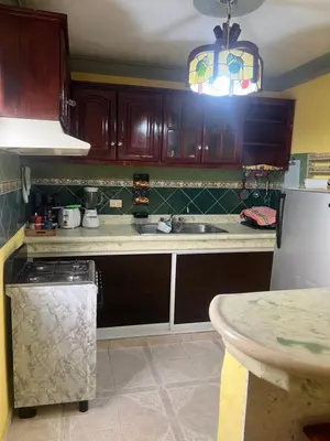 a kitchen with a sink and a counter top at Hostal Bless house in San Pedro de Macorís