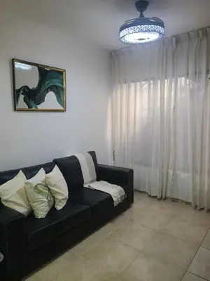 a black couch in a living room with a window at Mila's House in La Romana