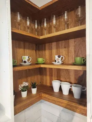 a shelf with cups and plates and bowls on it at Mila's House in La Romana