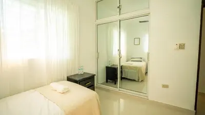 a room with two beds and a large mirror at Ketsys Home Near Santo Cerro in Concepción de La Vega
