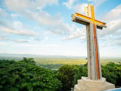 a large orthodox cross on top of a hill at Ketsys Home Near Santo Cerro in Concepción de La Vega