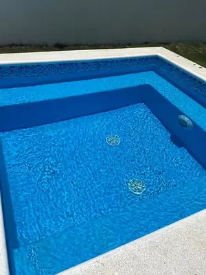 a blue swimming pool with water in it at VillaGuerra-Piscina-Billar-BBQ-WiFi-Cozy-3Br-5Bds-7Pax in Guerra