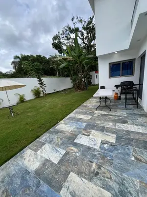 a patio with a table and an umbrella at VillaGuerra-Piscina-Billar-BBQ-WiFi-Cozy-3Br-5Bds-7Pax in Guerra