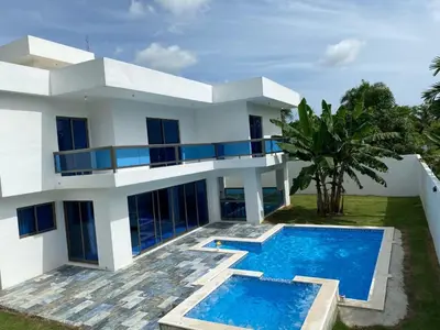a white house with a swimming pool in front of it at VillaGuerra-Piscina-Billar-BBQ-WiFi-Cozy-3Br-5Bds-7Pax in Guerra