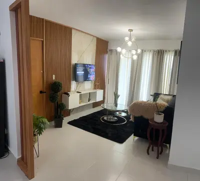 a living room with a couch a table and a tv at Hermoso y amplio apartamento de 3 habitaciones y 2 baños ! in San Pedro de Macorís