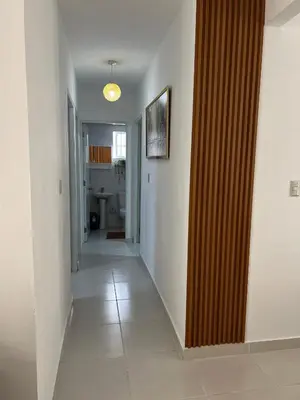 a hallway with a wooden partition in a house at Hermoso y amplio apartamento de 3 habitaciones y 2 baños ! in San Pedro de Macorís