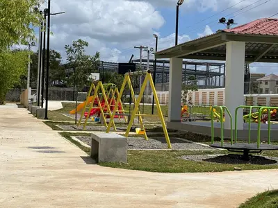 a playground with yellow equipment in a park at Hermoso y amplio apartamento de 3 habitaciones y 2 baños ! in San Pedro de Macorís