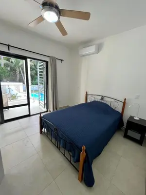 a bedroom with a bed and a ceiling fan at Brandnew 3 BR villa in Cabarete in Cabarete