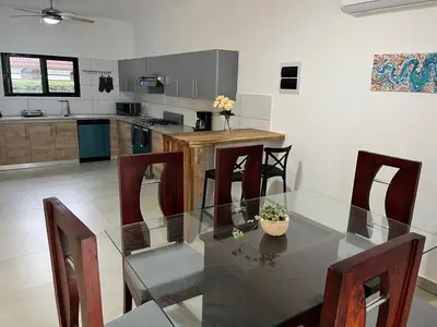 a dining room with a glass table and chairs at Brandnew 3 BR villa in Cabarete in Cabarete