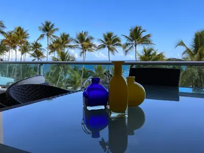three vases sitting on a table with palm trees in the background at Marbella-SeaView-FrontBeach-Cozy-2Br-2Bds-4Pax-WiFi in Villas del Mar