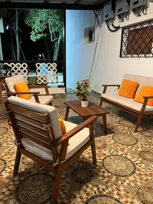 a patio with two chairs and a couch and a table at Villa Jarabacoa in Concepción de La Vega