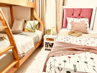 a bedroom with two bunk beds and a pink headboard at La casa del almendro in Concepción de La Vega