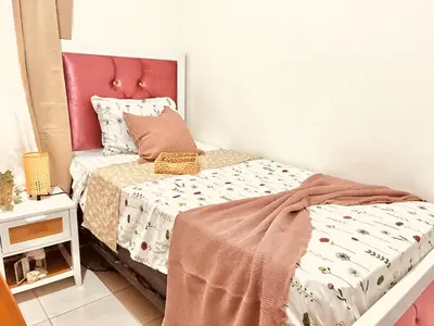 a small bedroom with a bed with a pink headboard at La casa del almendro in Concepción de La Vega