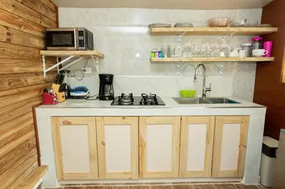 a kitchen with a sink and a microwave at Casa Palma El Limon Samana in El Limón