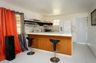 a kitchen with a counter and two bar stools at Casa Palma El Limon Samana in El Limón