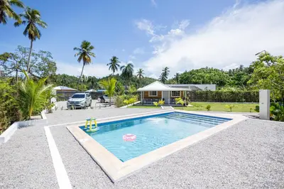 a swimming pool in a yard with a house at Casa Palma El Limon Samana in El Limón