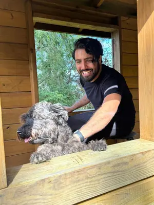 a man with a dog in a dog house at Kaleidoscopic Apartment in La Majagua