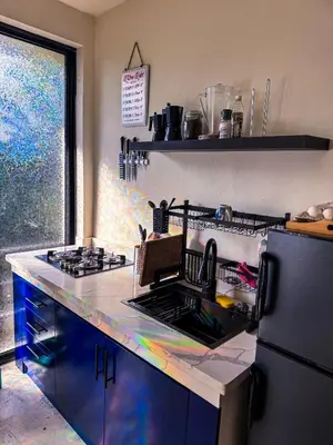 a kitchen with a stove and a sink and a refrigerator at Kaleidoscopic Apartment in La Majagua