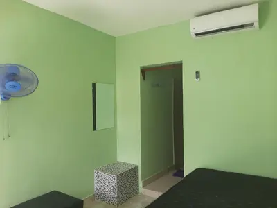 a room with a bed and a fan and a door at Una tarde trankilo in Sabana de Nisibón