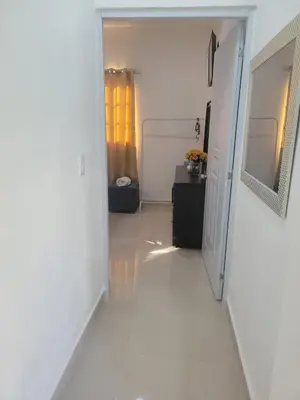 a hallway with white walls and a white floor at The Omelís House in Santa Bárbara de Samaná